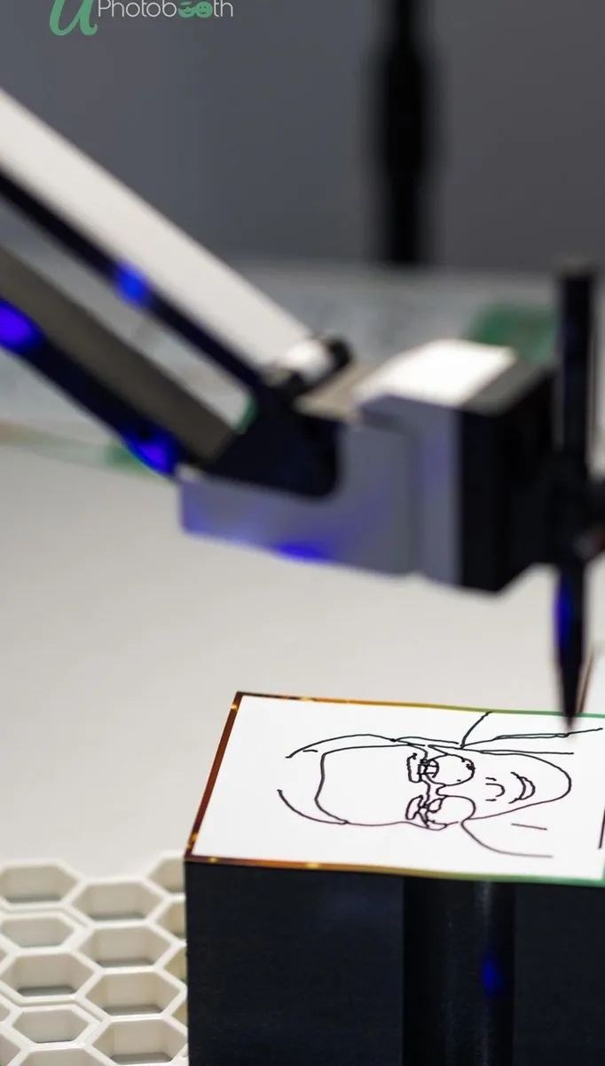 Close-up of a robot arm using a pen to draw a portrait in ink