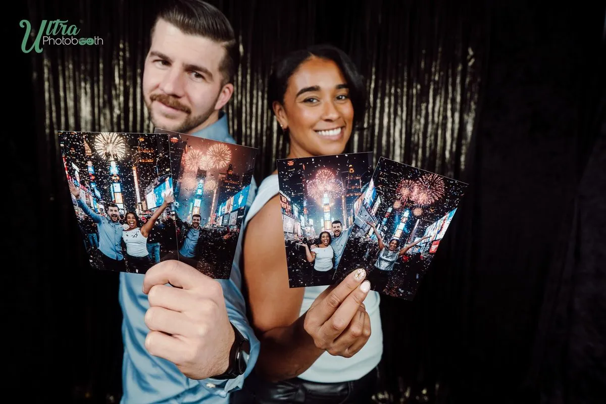 Two guests displaying a fan of colorful AI party portrait prints