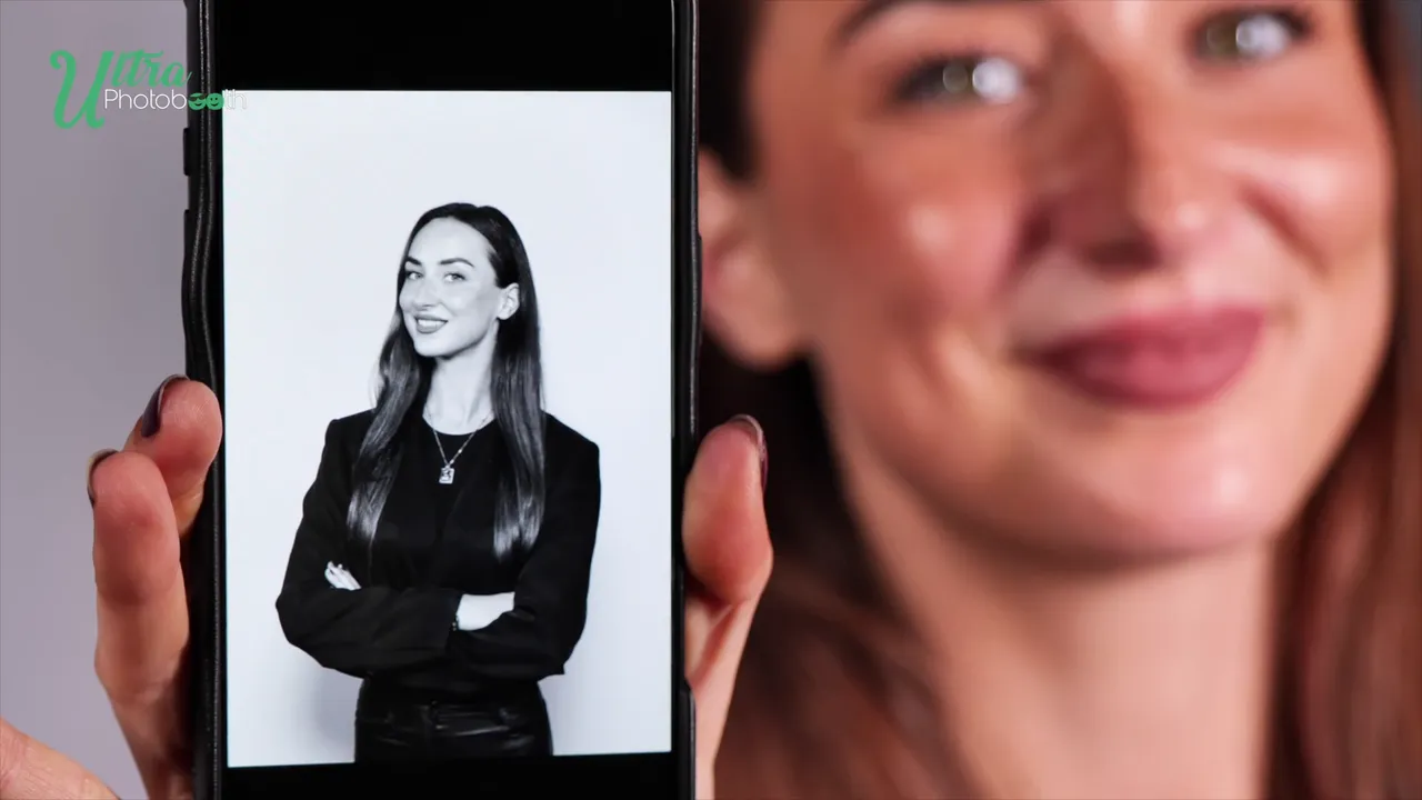 Guest showing a black-and-white headshot on her phone