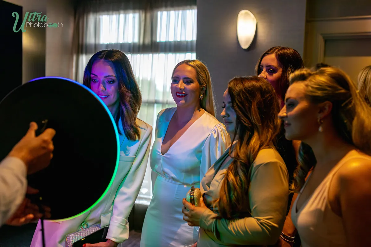Guests gathering in front of a handheld roaming iPad booth with a ring light