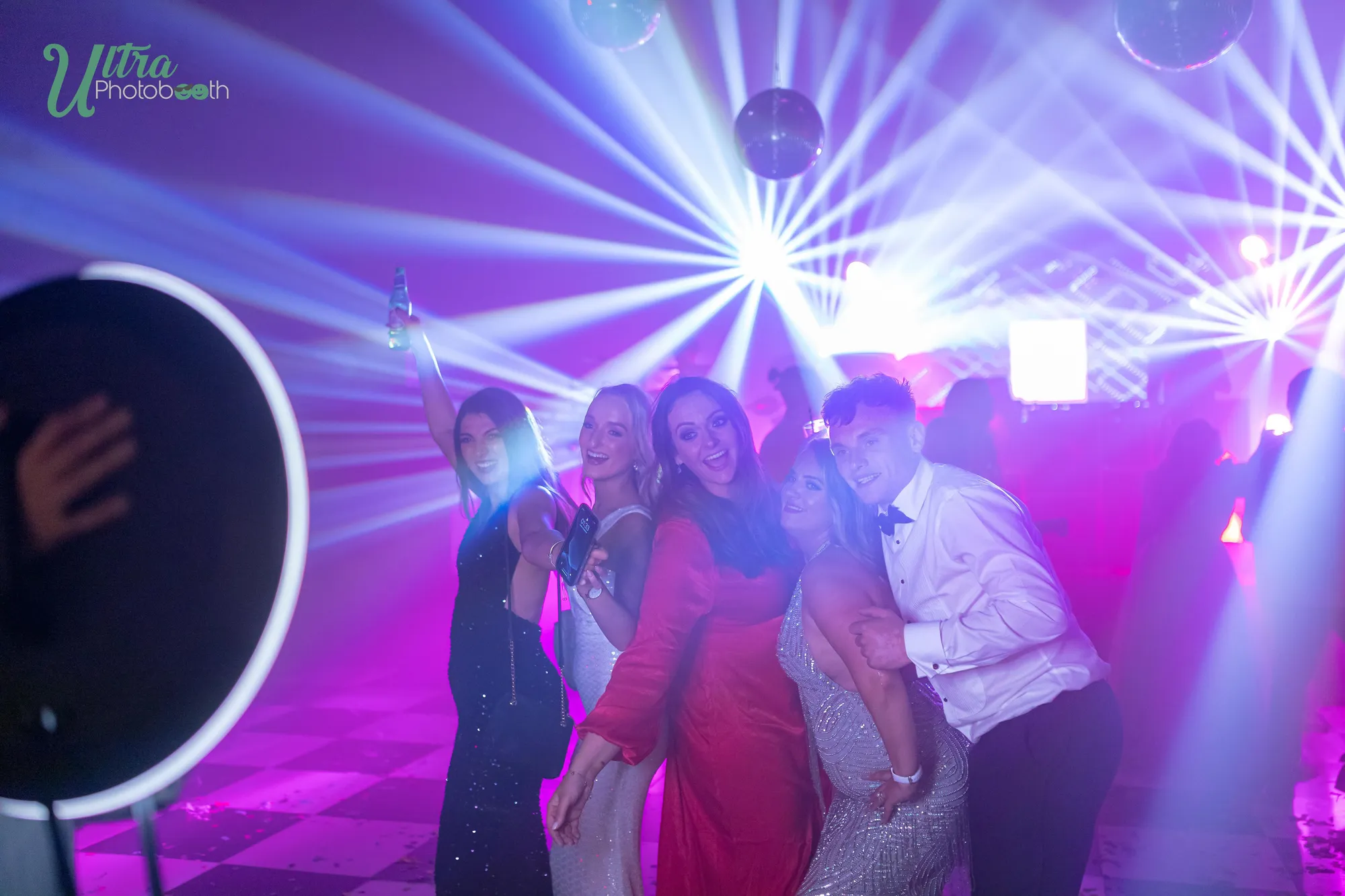 Roaming iPad ring light aimed at a group of guests on a dance floor