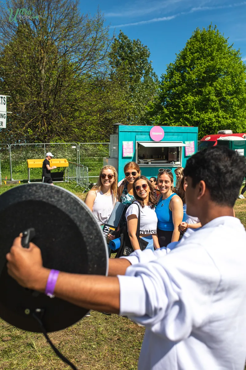 Attendant holding a roaming iPad ring light for guests at an outdoor event