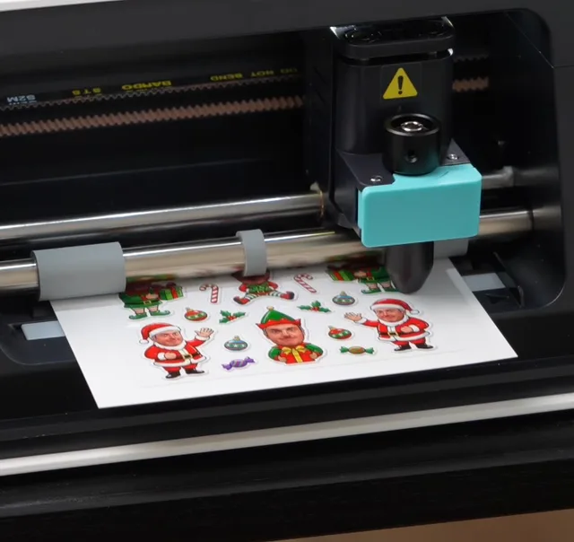 Cutting machine tracing the individual shapes on a printed sticker sheet