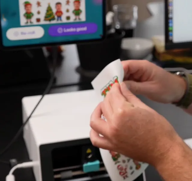 A guest peeling an illustrated sticker from a personalized printed sheet